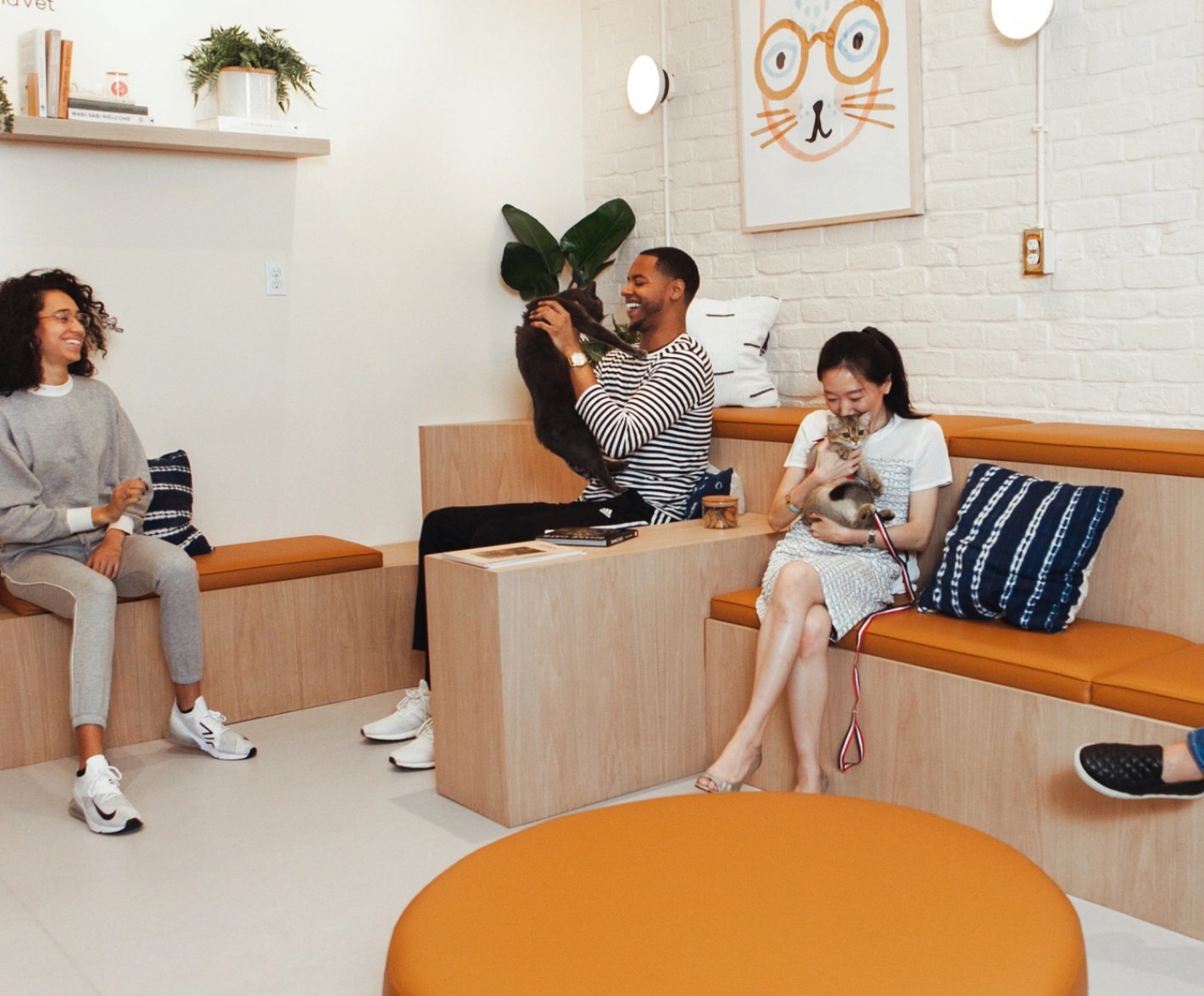 A group of people sitting on couches in a waiting room.