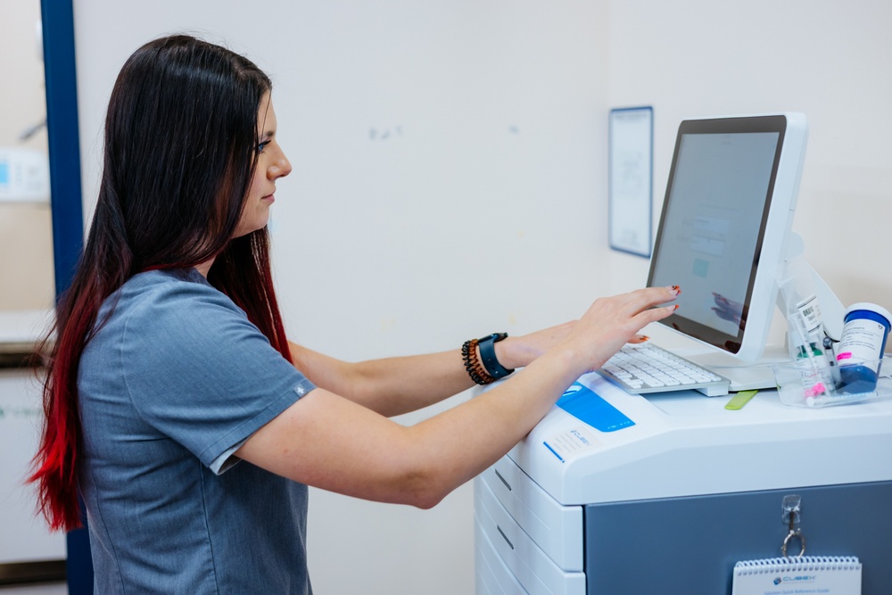 Bond Vet team member using a CUBEX medication management machine