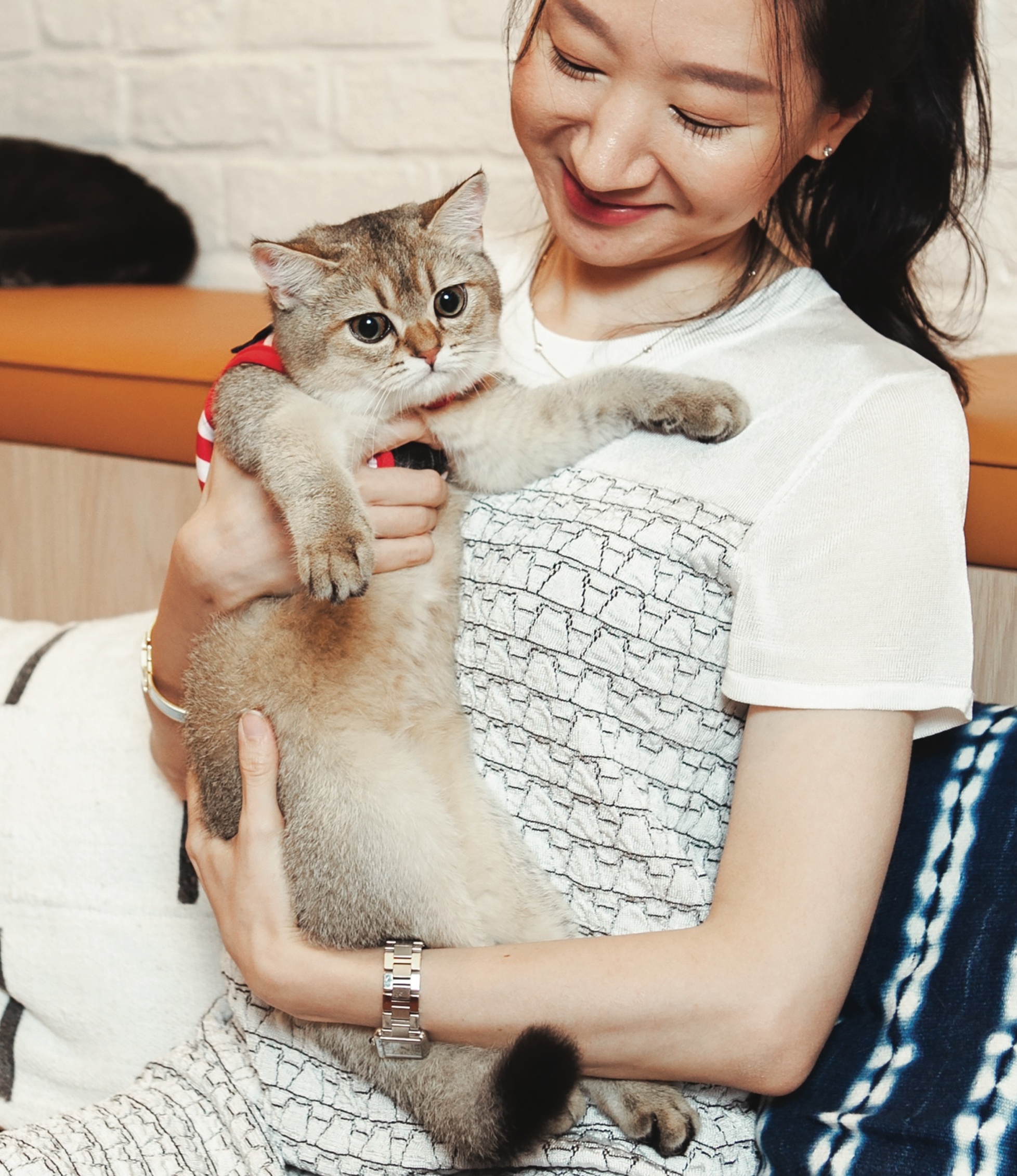 Two women with a dog and a cat